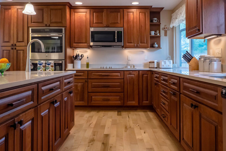 cherry kitchen cabinet with light floor